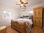 Bright, colorful bedroom with a ceiling fan and A/C unit